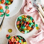 Rainbow pancake cereal in a small white bowl.