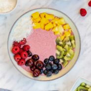 Rainbow smoothie bowl with colorful toppings.