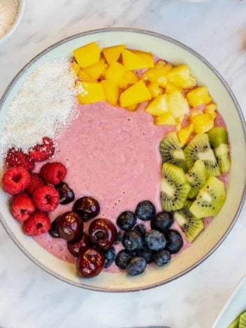 Rainbow smoothie bowl with colorful toppings.